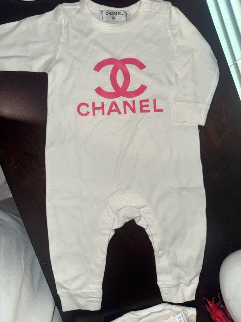 CHANEL White Footed Baby One-Piece with Pink Logo
